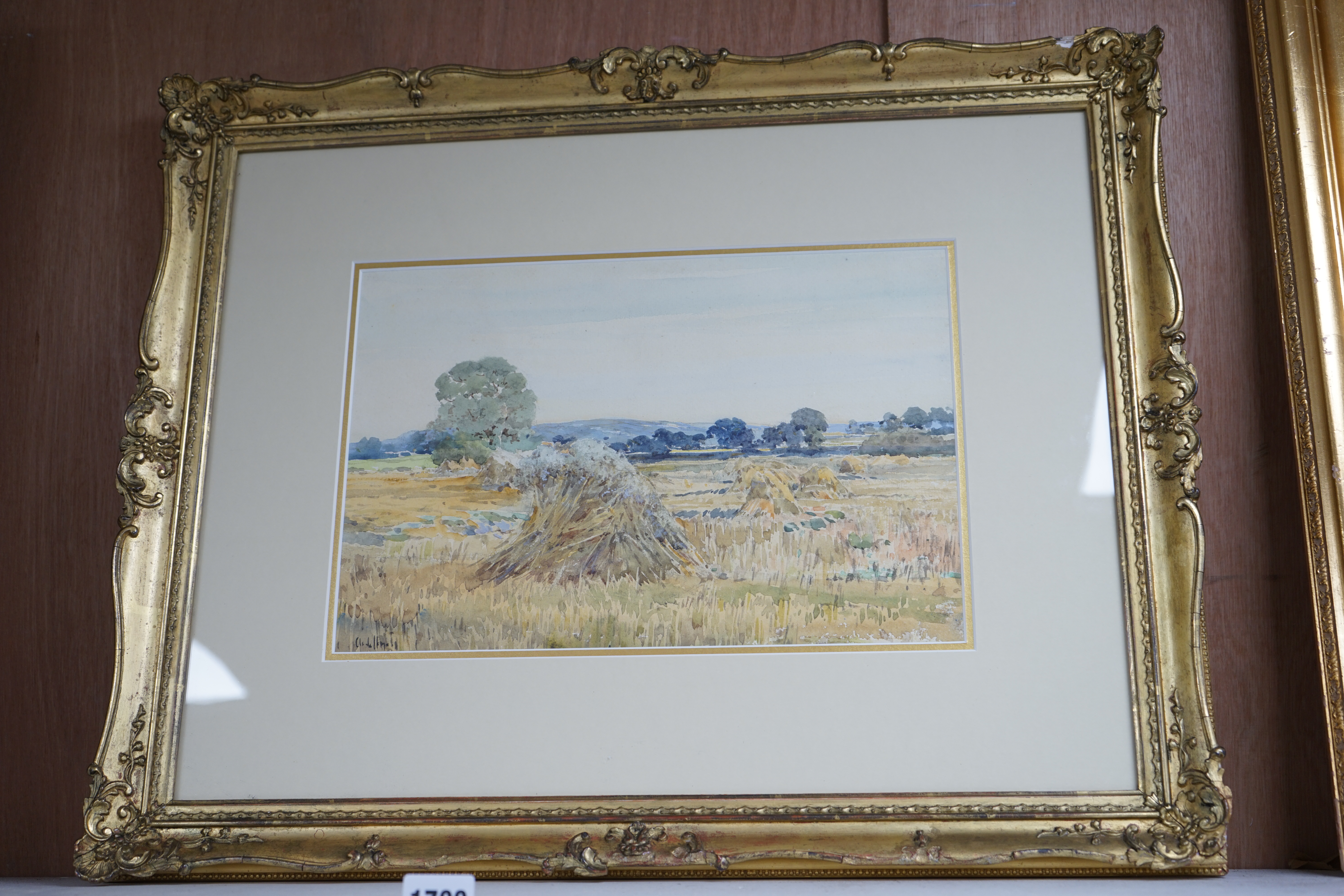 Claude Hayes (1852-1922), two watercolours, 'Haymaking, Norfolk' and 'Cornfield near Bredon, Worcestershire', each signed, 24 x 34cm, gilt framed. Condition - poor to fair, some staining and foxing